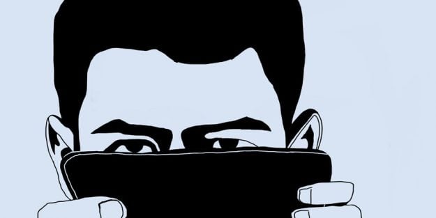 Sherwin looks out from behind his cellphone