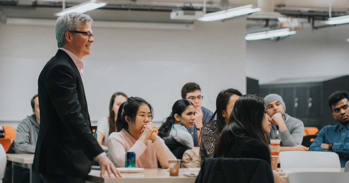 David Cory stands in front of a class of engineers at the University of Calgary, working through some EI trainings.
