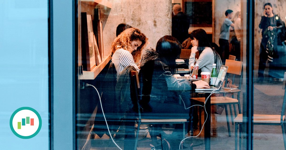 Women working and collaborating in a coffee shop.