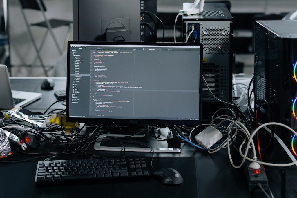 Black Flat Screen Computer Monitor and Keyboard on White Desk